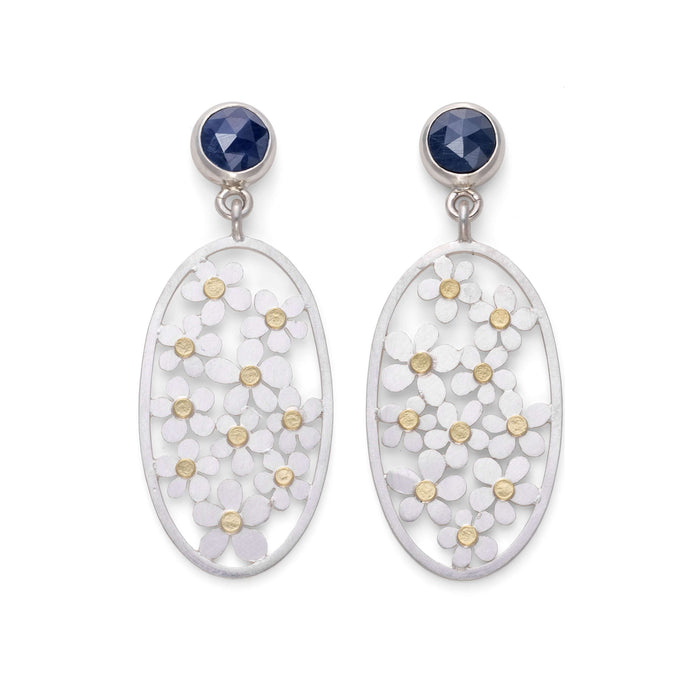 silver sweet chestnut earrings on a hand by diana greenwood jewellery