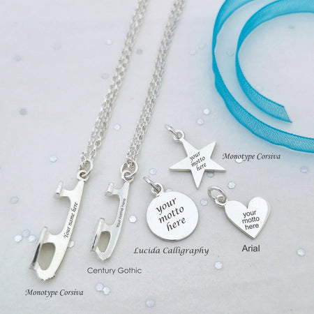Silver necklaces with customizable ice skate blade pendants on a light gray background
