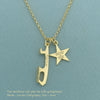 Gold necklace with a blade and star pendant on a teal background
