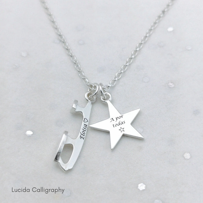 Silver ice skating necklace with engraved personalisation on a light gray background