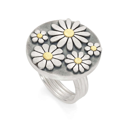 Silver ring with daisy flower designs on a white background
