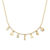 Gold necklace with various charms on a white background