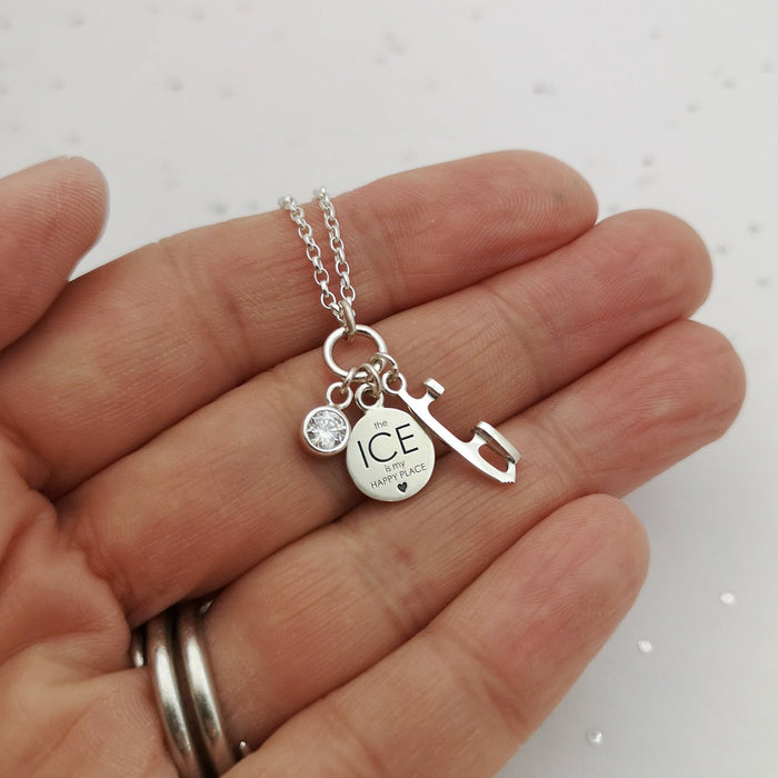 happy place silver ice charms necklace being held in a hand