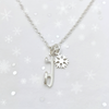 silver ice skate blade and snowflake ice skating necklace on a snowflake background