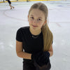 Young girl in a black outfit on an ice rink