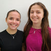 Two figure skaters wearing Snowflake Ice Skating Necklaces | Ice Skating Jewellery
